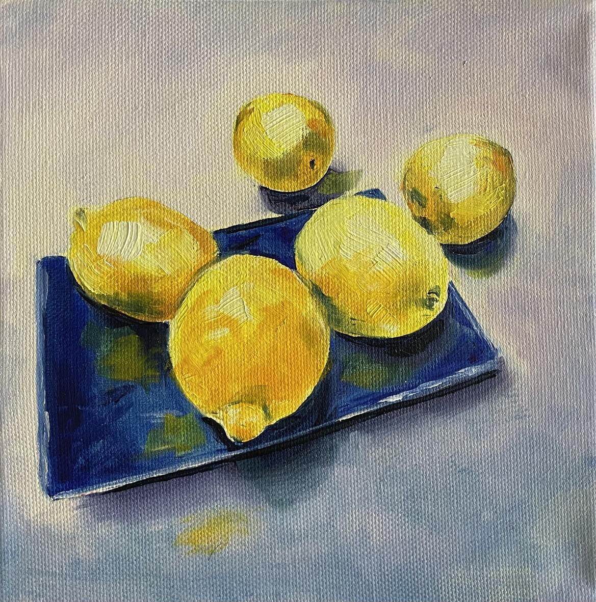 Five Lemons on blue plate